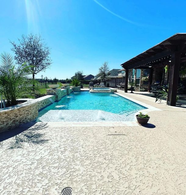 white natural sealed concrete sealed deck with a blue water pool